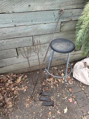 IRON WEDGES, RUSTIC LOOKING FORKS, A HORSE SHOE AND A BAR STOOL