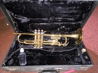 HOLTON BRASS TRUMPET WITH CASE, SLIDE OIL, MUSIC AND PINK LYRE