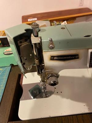 VINTAGE DRESSMAKERS SEWING MACHINE IN CABINET WITH SEWING NOTIONS AND MORE