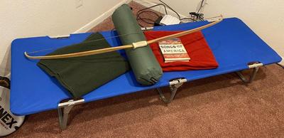BOW, SLEEPING COT, WOOL BLANKET, FLEECE BLANKET, INFLATABLE SLEEPING PAD, AND A SONG BOOK FOR SINGING WHILE YOU CAMP!