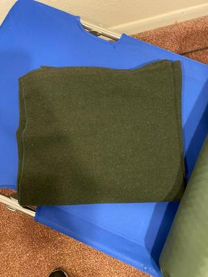BOW, SLEEPING COT, WOOL BLANKET, FLEECE BLANKET, INFLATABLE SLEEPING PAD, AND A SONG BOOK FOR SINGING WHILE YOU CAMP!