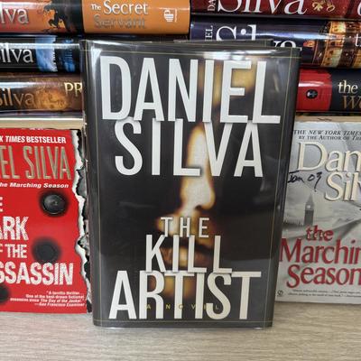 LOT 209L: Daniel Silva Novel Collection incl. 2004 Signed Copy of “A Death in Vienna”