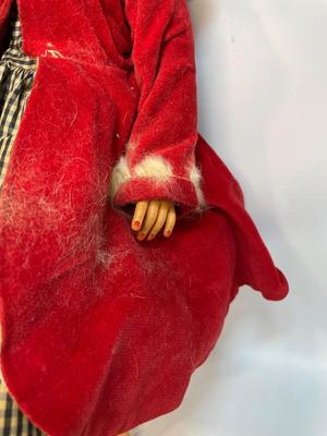 Vintage doll in red velvet jacket