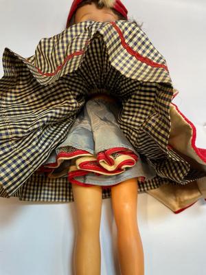 Vintage doll in red velvet jacket