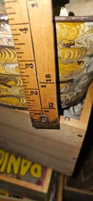 Metal bucket with Lion's Heads handles full of bones, stones and glass