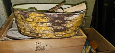 Metal bucket with Lion's Heads handles full of bones, stones and glass