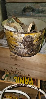 Metal bucket with Lion's Heads handles full of bones, stones and glass