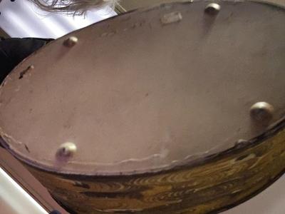 Metal bucket with Lion's Heads handles full of bones, stones and glass
