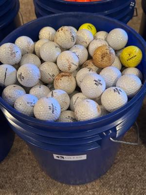 A bucket full of used Golf Balls