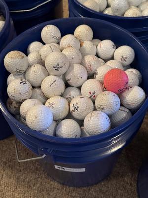 A bucket full of used Golf Balls