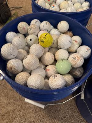 A bucket full of used Golf Balls
