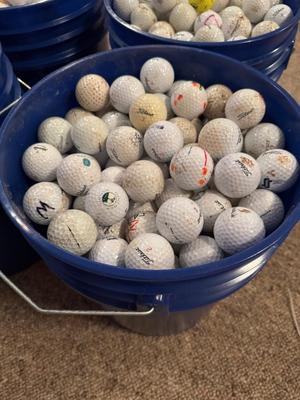 A bucket full of used Golf Balls