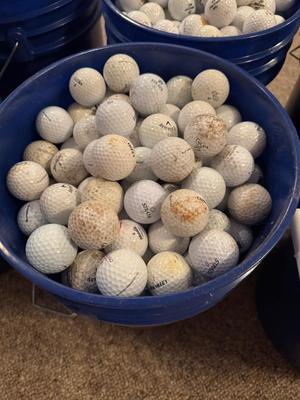 A bucket full of used Golf Balls