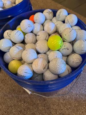 A bucket full of used Golf Balls