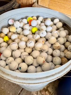 A 32 Gallon Can full of used Golf Balls