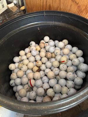 A 32 Gallon Can 3/4 full of used Golf Balls