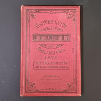 LOT 195: 1876 Philadelphia Centennial Exhibition Visitors Guide w/ Brass Eagle Flag Topper, Bailey Banks & Biddle Co. Miniature...