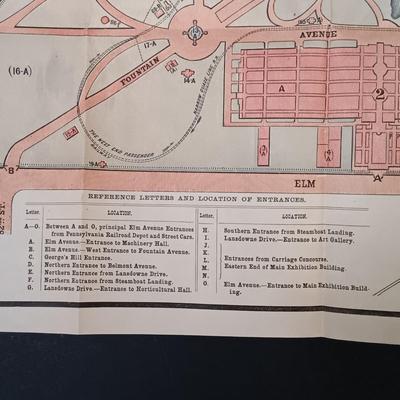 LOT 195: 1876 Philadelphia Centennial Exhibition Visitors Guide w/ Brass Eagle Flag Topper, Bailey Banks & Biddle Co. Miniature...