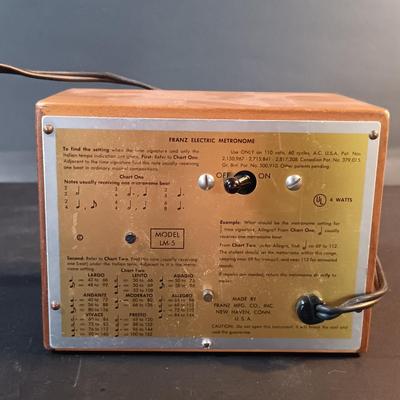 LOT 205: Vintage Franz Electric Metronome with Musical Instrument Related Books and Accessories
