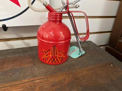 TIN TEXACO SIGN AND OIL CAN, ALONG WITH A HAND STRIPED OIL CAN.
