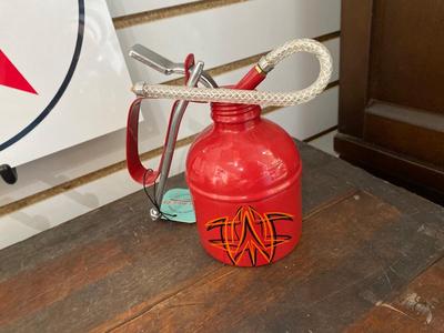 TIN TEXACO SIGN AND OIL CAN, ALONG WITH A HAND STRIPED OIL CAN.