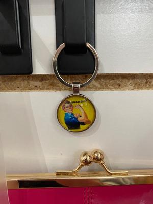 ROSIE THE RIVETER KEYCHAIN ALONG WITH HER DISTANT RELATIVES WINDOW STICKER, TIN FLAMINGO ROAD SIGN, AND MINI BLUETOOTH RADIO