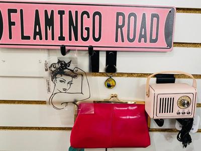ROSIE THE RIVETER KEYCHAIN ALONG WITH HER DISTANT RELATIVES WINDOW STICKER, TIN FLAMINGO ROAD SIGN, AND MINI BLUETOOTH RADIO