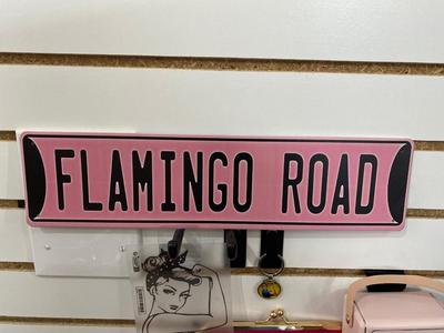 ROSIE THE RIVETER KEYCHAIN ALONG WITH HER DISTANT RELATIVES WINDOW STICKER, TIN FLAMINGO ROAD SIGN, AND MINI BLUETOOTH RADIO