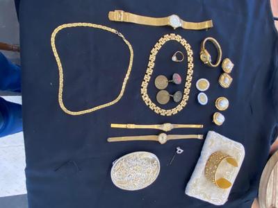A VARIETY OF GOLD TONE WATCHES, JEWELRY AND A BELT BUCKLE