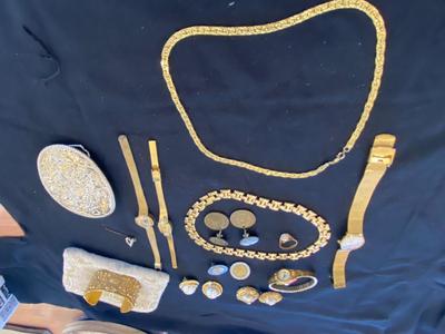 A VARIETY OF GOLD TONE WATCHES, JEWELRY AND A BELT BUCKLE