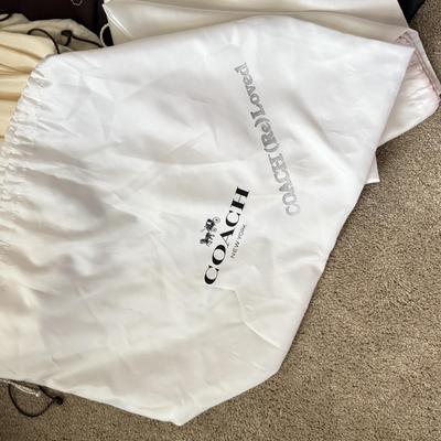 LOT 413L: Collection of Designer Bag Dust Covers: Michael Kors, Coach, Betsey Johnson, Dooney & Bourke