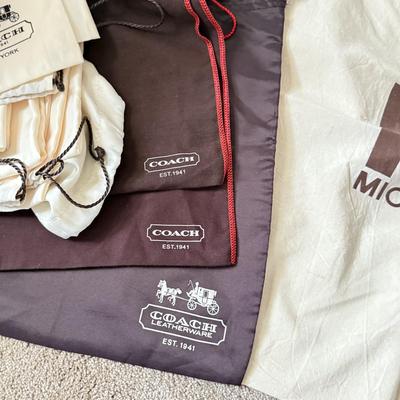 LOT 413L: Collection of Designer Bag Dust Covers: Michael Kors, Coach, Betsey Johnson, Dooney & Bourke