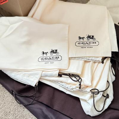 LOT 413L: Collection of Designer Bag Dust Covers: Michael Kors, Coach, Betsey Johnson, Dooney & Bourke