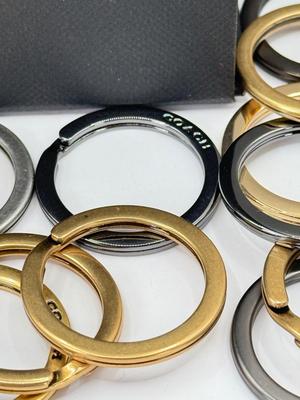 LOT 460J: 18” Coach Gold Tone Necklace, Coach Key Rings (18) & Gift Box