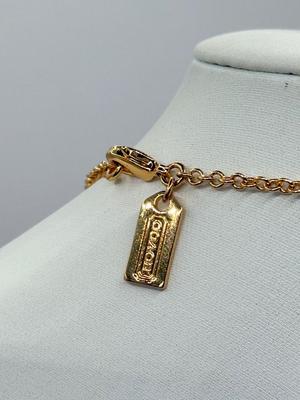 LOT 460J: 18” Coach Gold Tone Necklace, Coach Key Rings (18) & Gift Box