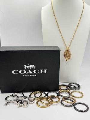 LOT 460J: 18” Coach Gold Tone Necklace, Coach Key Rings (18) & Gift Box