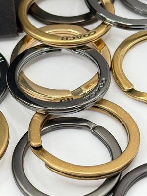 LOT 460J: 18” Coach Gold Tone Necklace, Coach Key Rings (18) & Gift Box