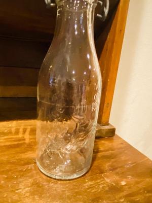 ANTIQUE MILK BOTTLE AND GLAZED STONEWARE JAR WITH LOCKING LID