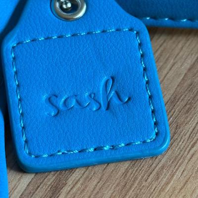 LOT 260: Sash Teal Bag, Brookstone Bag & More