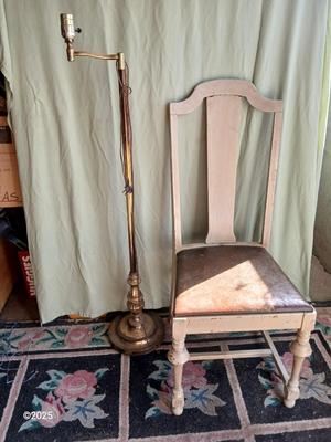 Antique highback diningroom chair with a brass colored swing arm floor lamp