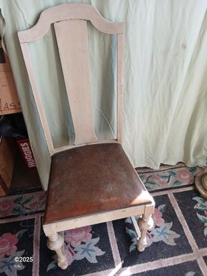 Antique highback diningroom chair with a brass colored swing arm floor lamp