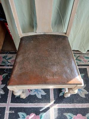 Antique highback diningroom chair with a brass colored swing arm floor lamp