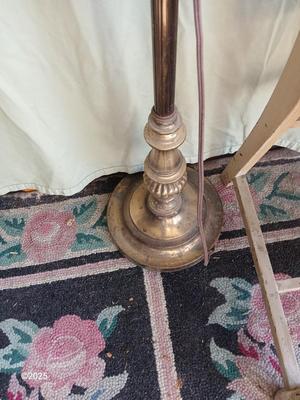 Antique highback diningroom chair with a brass colored swing arm floor lamp