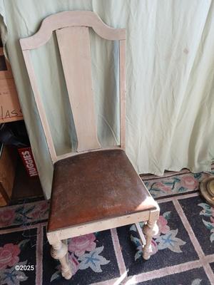 Antique highback diningroom chair with a brass colored swing arm floor lamp