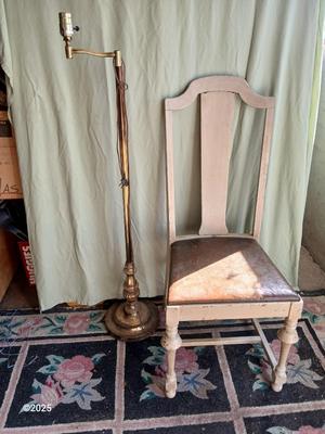 Antique highback diningroom chair with a brass colored swing arm floor lamp