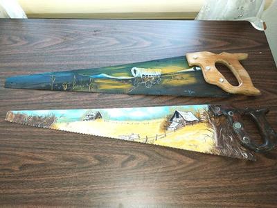 TWO HAND PAINTED SAWS SIGNED BY WICKHAM