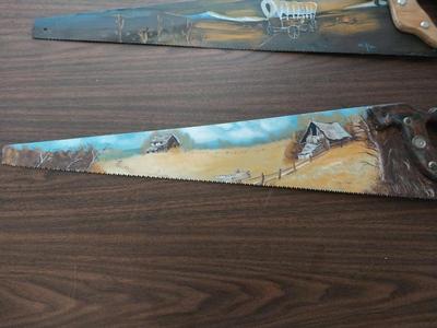 TWO HAND PAINTED SAWS SIGNED BY WICKHAM