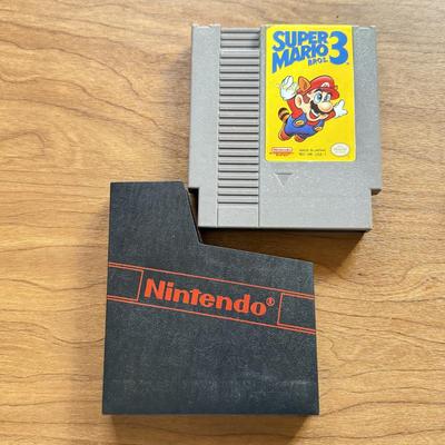 LOT 104F: 1985 Nintendo Entertainment System NES Game Cartridges w/ Nintendo Branded Sleeves: Super Mario Bros. 3 & Dr. Mario