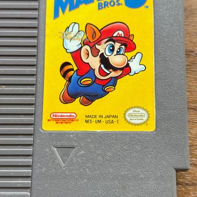 LOT 104F: 1985 Nintendo Entertainment System NES Game Cartridges w/ Nintendo Branded Sleeves: Super Mario Bros. 3 & Dr. Mario