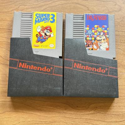 LOT 104F: 1985 Nintendo Entertainment System NES Game Cartridges w/ Nintendo Branded Sleeves: Super Mario Bros. 3 & Dr. Mario